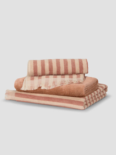 Stack of Sand Shell Pembroke Stripe and Fringe Edge Towels