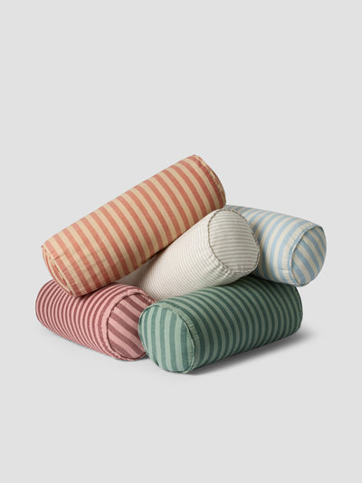 Stack of Bolster Cushions in striped patterns on a light gray background